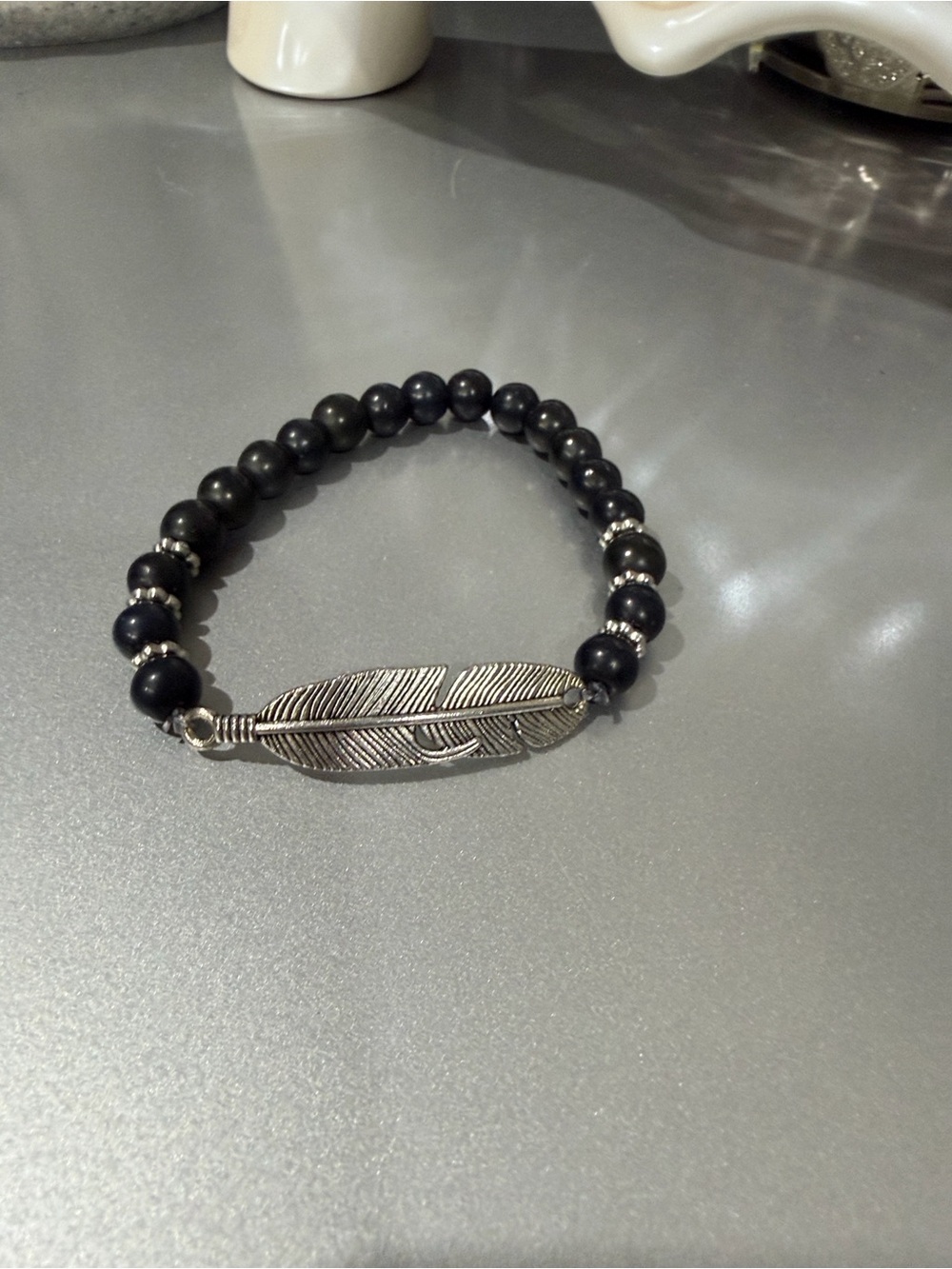 Black Beaded Bracelet with Silver Feather Accent